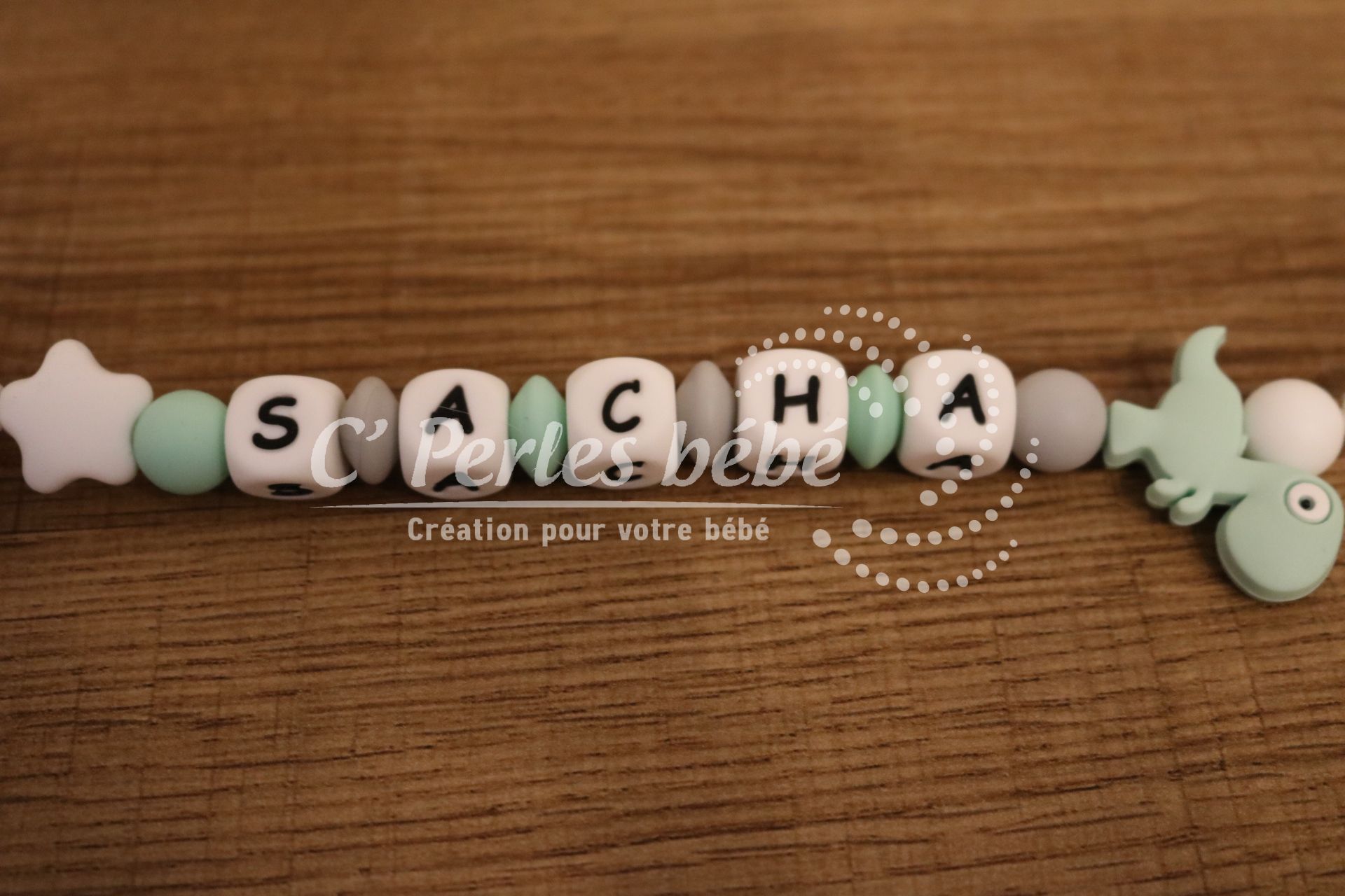 Attache tétine dinosaure